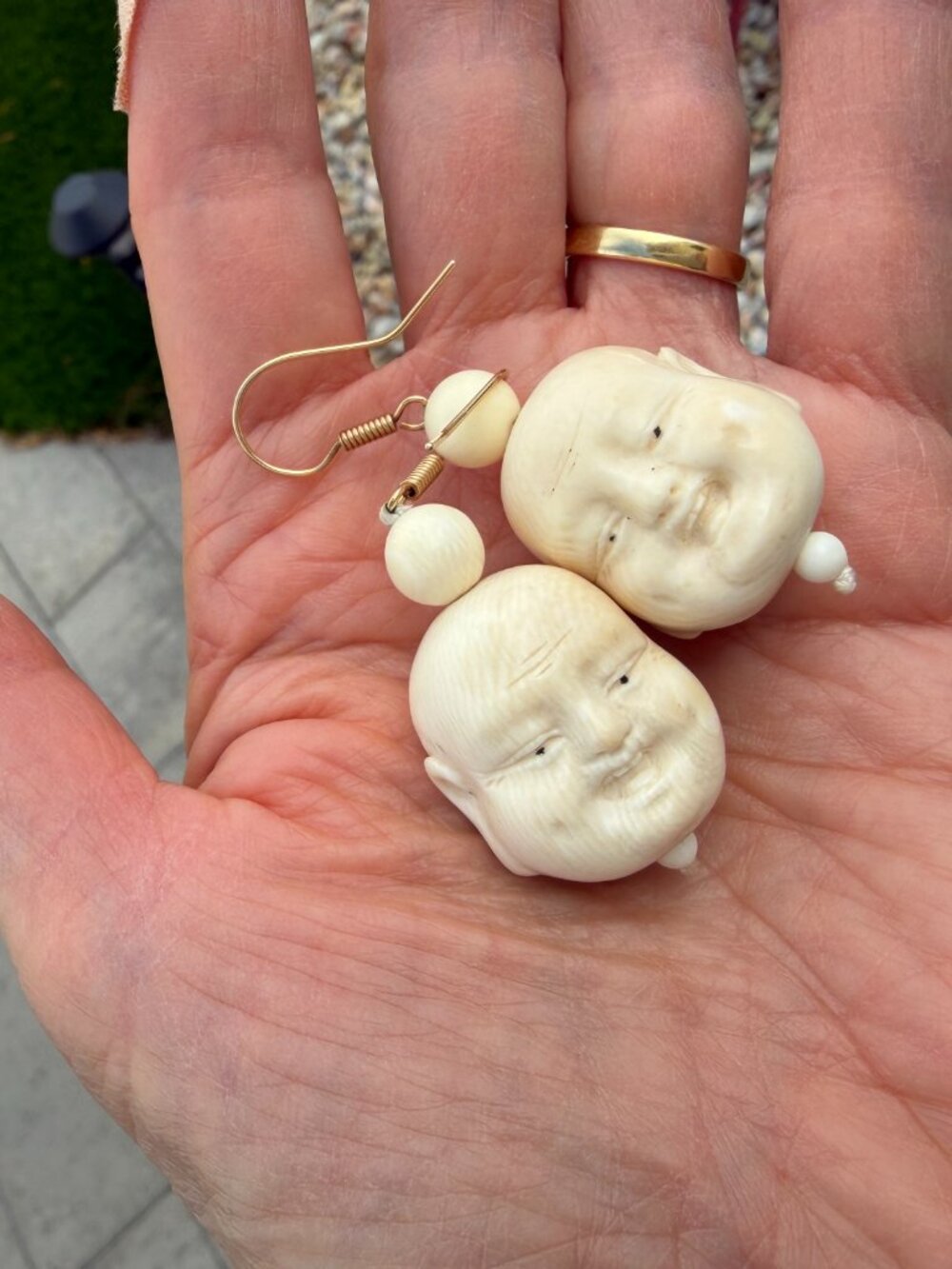 Vintage laughing Buddha earrings on a gold wire
